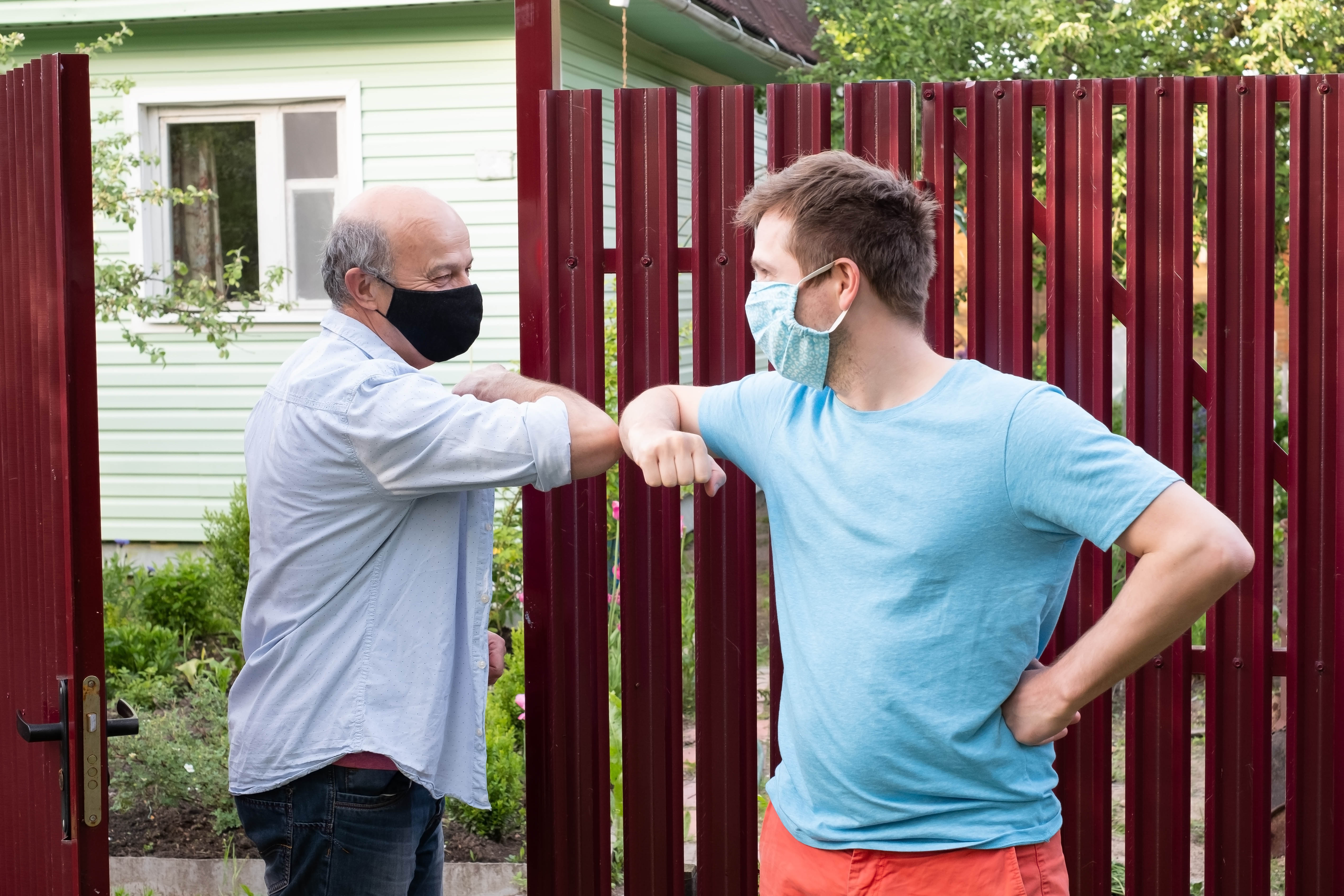 Neighbours offer each other support with an elbow bump